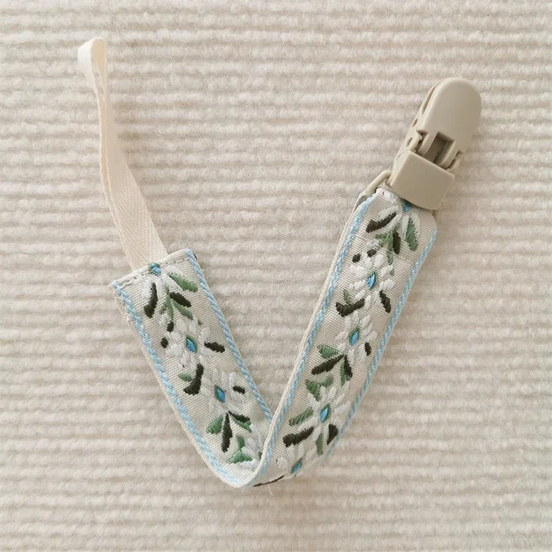 Attache tetine fleurs vertes