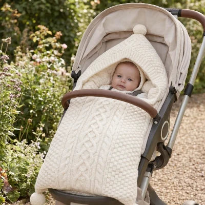 bébé dans sa poussette dans son nid d Ange cosy blanc prêt pour promenade